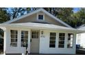 Cute bungalow with white trim and a spacious front porch at 4712 Caroline Ave, Indianapolis, IN 46205