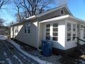 Side view of tan house with white sunroom at 4712 Caroline Ave, Indianapolis, IN 46205