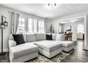Bright living room featuring a large sectional sofa, hardwood floors, and abundant natural light at 4926 Crittenden Ave, Indianapolis, IN 46205