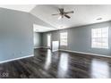 Spacious living room with dark hardwood floors, gray walls, and a ceiling fan at 7328 Woodside Dr, Avon, IN 46123