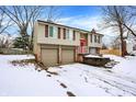 2-story house with red front door, 2-car garage, and snowy yard at 7803 Opelika Ct, Indianapolis, IN 46217