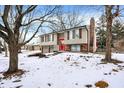 2-story house with red front door, 2-car garage, and snowy yard at 7803 Opelika Ct, Indianapolis, IN 46217