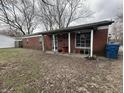 Charming brick home with covered porch and gravel driveway at 7903 Roseway Ct, Indianapolis, IN 46226
