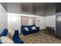 Spacious living room featuring blue velvet sofas and a neutral rug at 8224 Barry Rd, Indianapolis, IN 46219