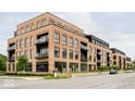 Contemporary brick building, featuring street-level storefronts and residential units above at 855 N East St # 302, Indianapolis, IN 46202