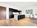 Modern kitchen with dark cabinetry, marble island, and stainless steel appliances at 855 N East St # 302, Indianapolis, IN 46202