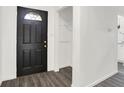 Clean entryway featuring a sleek black front door, modern flooring, and a convenient coat closet at 9157 Neptune Dr, Indianapolis, IN 46229
