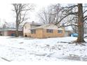 Side view of a ranch home with brick exterior and mature trees at 9157 Neptune Dr, Indianapolis, IN 46229