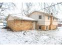 Rear view of a ranch home showcasing brick exterior and a patio at 9157 Neptune Dr, Indianapolis, IN 46229