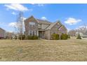 Well-maintained brick home with a spacious front yard under a bright sky at 11383 Sea Side Ct, Fishers, IN 46040