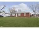 Ranch house with a large grassy yard at 1215 N Shortridge Rd, Indianapolis, IN 46219