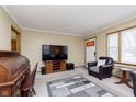 Living room features a large TV, comfortable seating, and a roll top desk at 1215 N Shortridge Rd, Indianapolis, IN 46219
