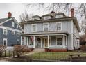 Charming multi-story home with welcoming front porch and wrought iron fence at 1319 N New Jersey St, Indianapolis, IN 46202