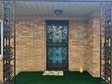 Close-up of the decorative metal security door and brick facade of this inviting home at 1350 N Graham Ave, Indianapolis, IN 46219