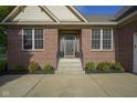 Inviting home entrance with brick facade, well-maintained steps, and manicured front garden at 16395 La Paloma Ct, Noblesville, IN 46060