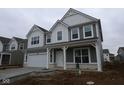 New two-story home featuring gray siding, white trim, covered porch, and an attached two-car garage at 16844 Silo Meadows Dr, Noblesville, IN 46060