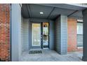 Gray front door and entryway with brick accents at 1852 Mcquat Pl, Indianapolis, IN 46202