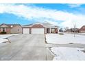 Brick ranch house with 3-car garage and covered porch at 1874 Buckthorn Dr, Columbus, IN 47201