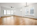 Spacious living room with hardwood floors, large windows, and a ceiling fan at 20035 Meadow Neck Rd, Westfield, IN 46074