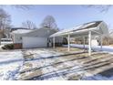 Attached garage with carport and snowy driveway at 2054 Horizon Blvd, Greenwood, IN 46143