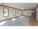 Bright and airy living room with large windows, carpet, and a ceiling fan for added comfort at 306 Vinewood N Dr, Brownsburg, IN 46112