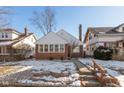 Brick ranch house with a snow-covered front yard at 31 N Kenmore Rd, Indianapolis, IN 46219
