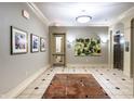 Elegant lobby with artwork and elevator access at 450 E Ohio St # 106, Indianapolis, IN 46204