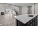 Bright, open-concept kitchen with a large island, modern appliances, and seamless flow into the adjacent living area at 5511 Sienna Ct, Brownsburg, IN 46112