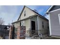 Tan house side view with black fence and brick pillars; winter scene at 952 Udell St, Indianapolis, IN 46208