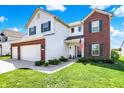 Charming two-story home with a brick accent and a beautifully landscaped front yard at 977 Capricorn Dr, Franklin, IN 46131