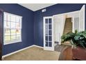 Comfortable office space with blue walls, natural light, and a view of the stairway at 977 Capricorn Dr, Franklin, IN 46131