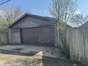 Detached garage with brown roll-up door, showing some wear at 1520 N Bancroft St, Indianapolis, IN 46201