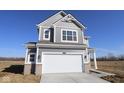 Charming two-story home with gray siding, white trim, and a spacious two-car garage at 2310 Marjorie Way, Shelbyville, IN 46176