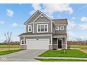 Charming two-story home with gray siding, white trim, two-car garage, and landscaped yard at 2310 Marjorie Way, Shelbyville, IN 46176