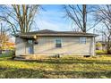 Classic single-story home with neutral siding, front porch, and well-maintained yard at 2319 N Rural St, Indianapolis, IN 46218
