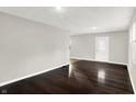 Living room with dark hardwood floors and neutral walls at 2319 N Rural St, Indianapolis, IN 46218