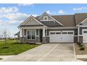 Charming home featuring a two-car garage, stone accents, and well-manicured lawn at 3617 Wrangler Dr, Bargersville, IN 46106