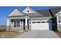 Attractive craftsman home with a stone facade, covered porch, and attached two-car garage on a sunny day at 3617 Wrangler Dr, Bargersville, IN 46106