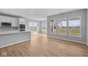 Bright living room featuring wood floors and large windows providing plenty of natural light at 3617 Wrangler Dr, Bargersville, IN 46106