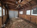 Empty garage interior with wooden walls and a garage door at 450 N Border St, Paragon, IN 46166