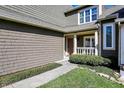 Inviting front entrance featuring a charming front door, trimmed shrubbery and manicured lawn at 4669 Stansbury Ln, Indianapolis, IN 46254