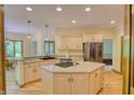 Bright kitchen with stainless steel appliances, granite countertops, and center island cooktop at 6012 Yellow Birch Ct, Avon, IN 46123