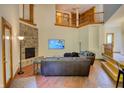 Spacious living room featuring a stone fireplace, hardwood floors, and a lofted library at 6012 Yellow Birch Ct, Avon, IN 46123