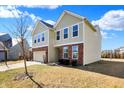 Charming two-story home with an attached two-car garage, brick accents, and a well-manicured lawn at 6115 Adler Ct, Whitestown, IN 46075