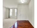 Spacious room featuring new carpet, fresh paint, and hardwood flooring at entry at 6115 Adler Ct, Whitestown, IN 46075