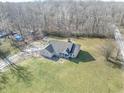 Brick ranch home with a large grassy yard and wooded surroundings at 8662 N Kitchen Rd, Mooresville, IN 46158