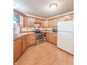 Spacious kitchen with oak cabinets, stainless steel appliances, and hardwood floors at 8662 N Kitchen Rd, Mooresville, IN 46158