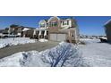 Two story home with attached garage, partially covered in snow at 8836 Hornady Ct, Indianapolis, IN 46239