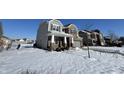 Two story home with light brown and brick exterior, and a snow covered lawn at 8836 Hornady Ct, Indianapolis, IN 46239