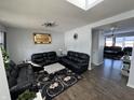 Spacious living room with leather furniture and hardwood floors at 8836 Hornady Ct, Indianapolis, IN 46239